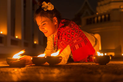 Midsection of man with illuminated lighting equipment