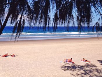 Tourists sunbathing on beach
