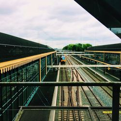 Train on railroad track against cloudy sky