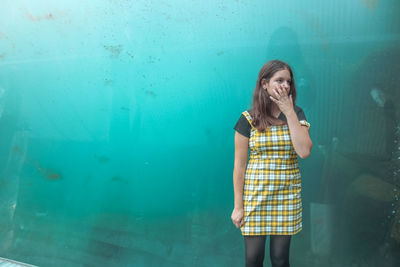 Woman standing against wall