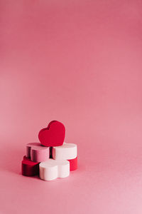 Close-up of heart shape against pink background