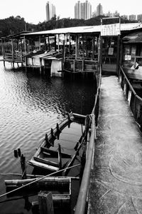 Pier over canal against clear sky