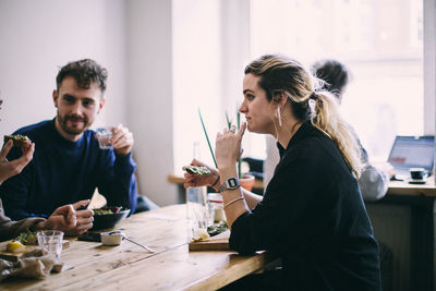 Young couple sitting on table