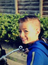 Portrait of smiling boy holding camera