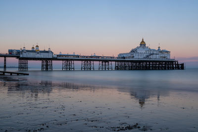 Wide view of eastbourne pier at sunset long exposure with clear sky