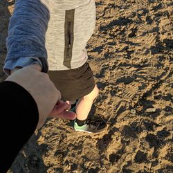 Low section of man and woman standing on land