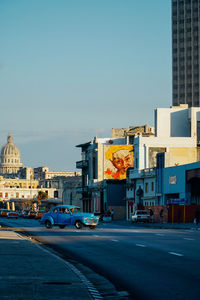 View of city street and buildings against sky