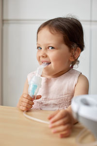 Portrait of young woman drinking water