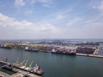 High angle view of river and cityscape against sky