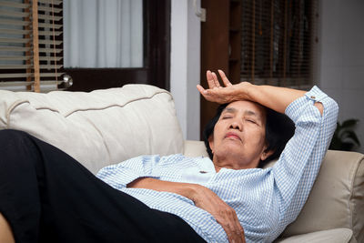 Man lying down on sofa at home