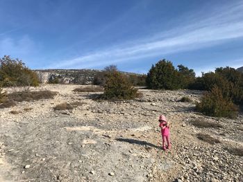 Cute girl standing against blue sky