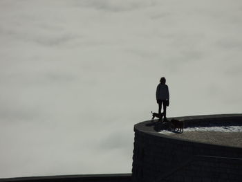 Rear view of man standing against sky