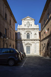 Street amidst buildings in city against sky