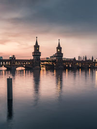 Reflection of building in river at sunset