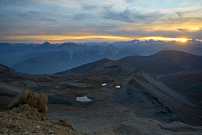 Scenic view of mountains against sky during sunset