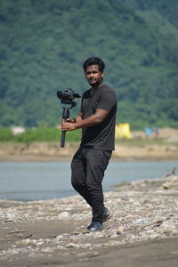 Portrait of young man standing on land