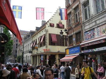 People on street amidst buildings in city