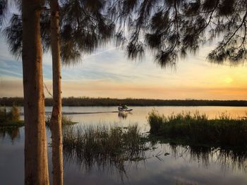 Scenic view of lake against sky at sunset