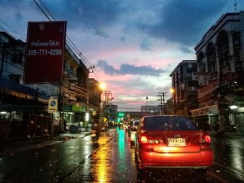 Cars on road in city at dusk