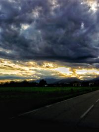 Dramatic sky over road during sunset