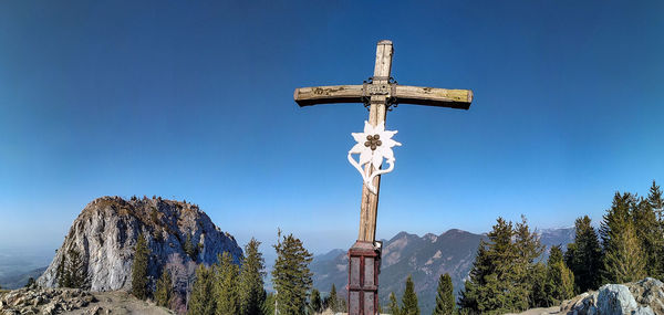 Low angle view of cross against clear blue sky