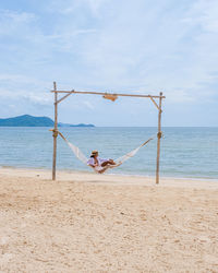 People on beach against sky