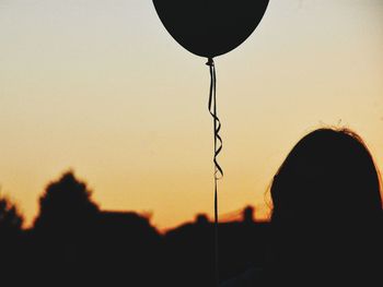 Close-up of silhouette person against sky during sunset