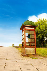 Built structure by street against blue sky