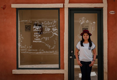Portrait of man standing against door