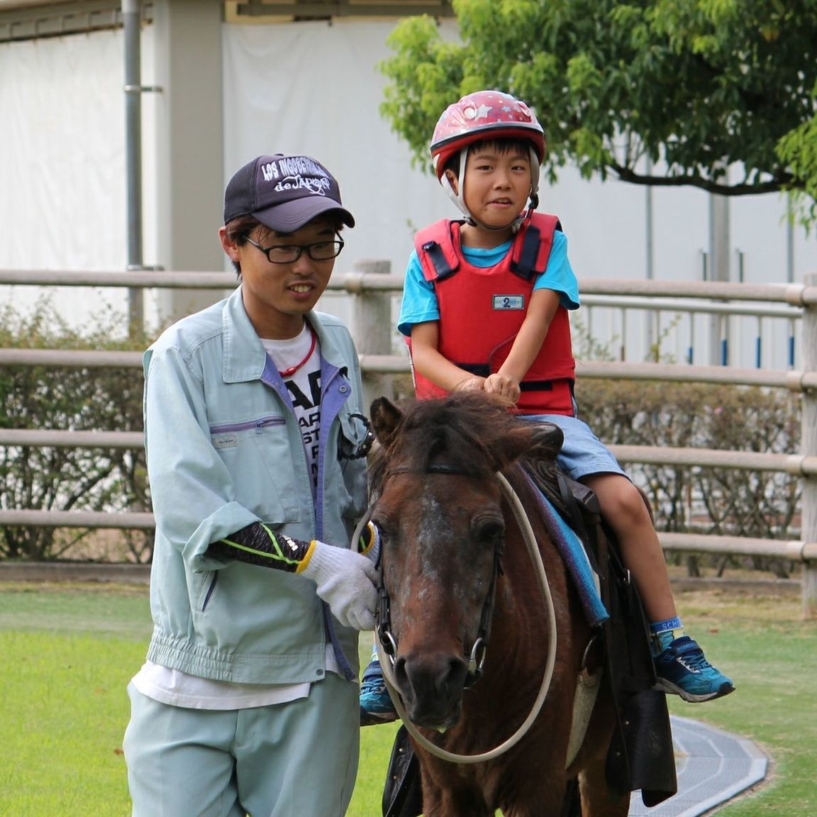 boys, helmet, childhood, headwear, front view, two people, leisure activity, real people, smiling, sports helmet, cap, day, lifestyles, outdoors, sport, togetherness, happiness, cycling helmet, mammal, animal themes, people