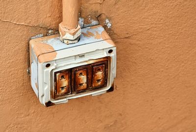 The dangerous old electric plug on wall