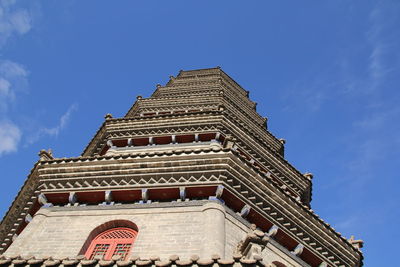 Low angle view of building against blue sky