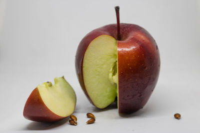 Close-up of apple on table against white background