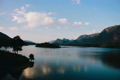 Scenic view of lake and mountains against sky