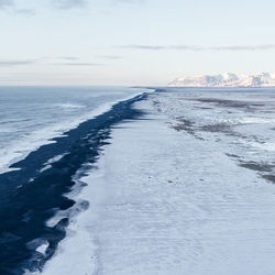 Scenic view of sea against sky during winter