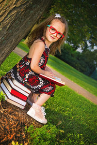 Portrait of young woman sitting on field