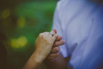 Close-up of couple holding hands