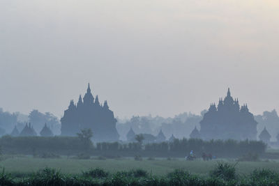 Panoramic view of trees and buildings against sky