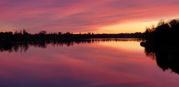 Scenic view of lake against romantic sky at sunset