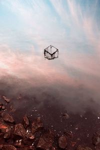 Low angle view of umbrella against sky during sunset