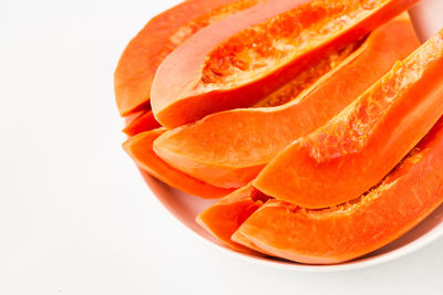 High angle view of orange fruit against white background