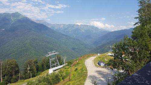 Scenic view of road amidst mountains against sky