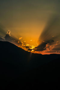 Scenic view of silhouette mountain against sky at sunset