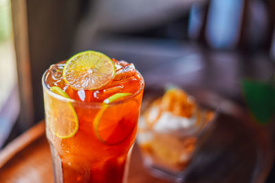 Close up iced lemon tea in a glass on wood table,fresh homemade