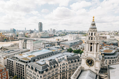 Cityscape against cloudy sky