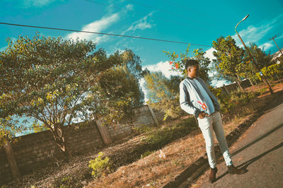 Man standing by plants against sky