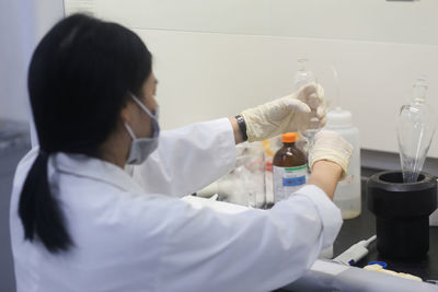 Vietnamese woman scientist making an experiment in the laboratory