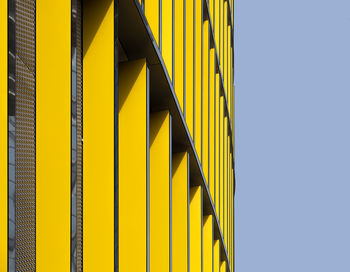 Low angle view of yellow building against clear sky