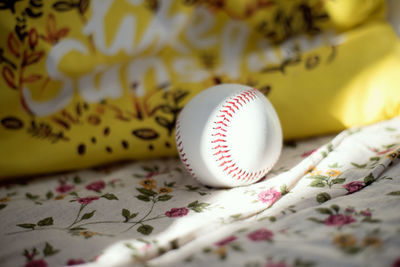 Close-up of baseball on textile