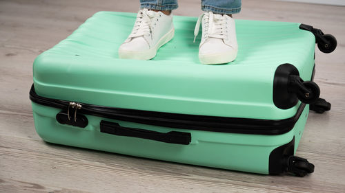 Low section of woman in suitcase